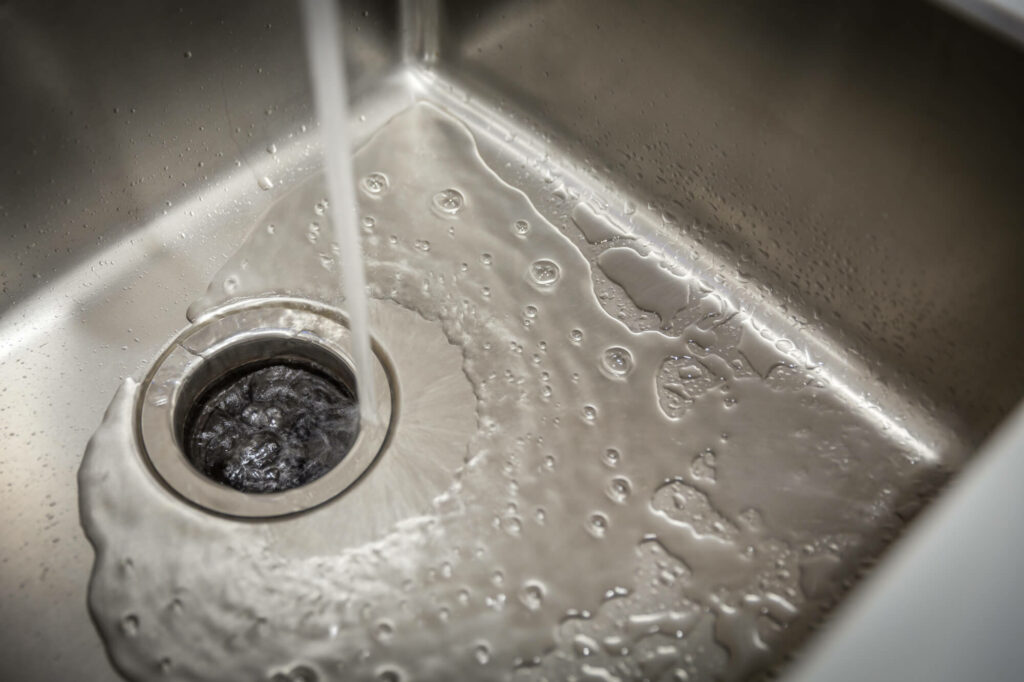 2. Myth: Running water while using the garbage disposal helps it work better.